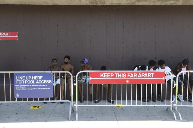 People wait to enter a swimming pool in New York on Monday.